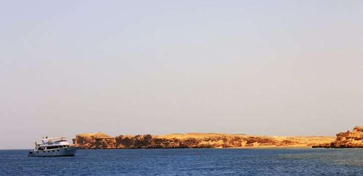 White ship moving by the red sea