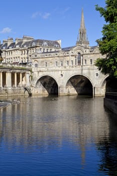 Pulteney Bridge and the River Avon in Bath.  St Michael's Church can be seen in the background.