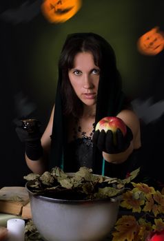 Witch giving poisoned apple at Halloween night