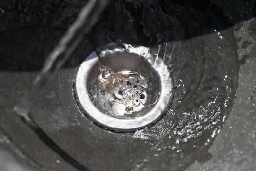 Water flows into drain hole, closeup