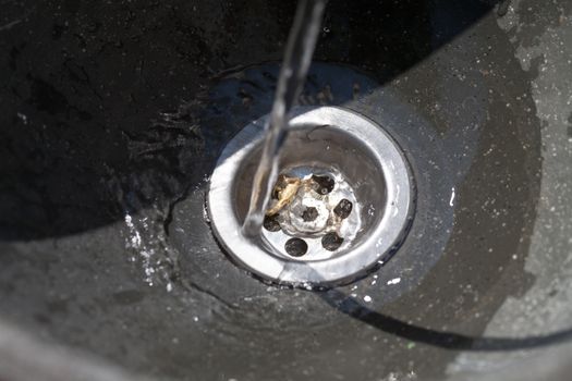 Water flows into drain hole, closeup