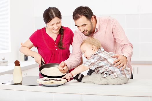 happy family makes pancakes in the kitchen