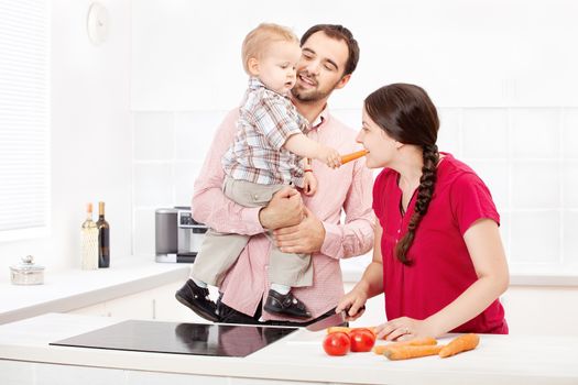 Happy family preparing food in the kitchen