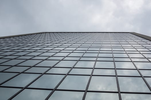 Abstract clouds reflecting in windows on tall building