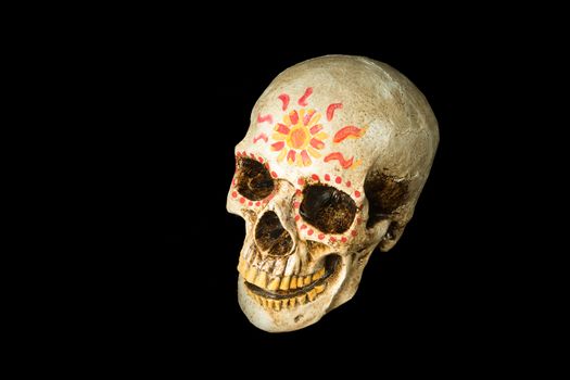 Hand painted Dia de los Muertos (Day of The Dead) skull isolated on black background