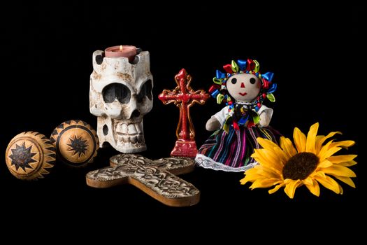 Traditional Day of the Dead (Dia de los muertos) Mexican alter with skull candle, cross, maracas, sunflower and Mexican doll.