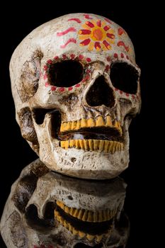 Hand painted Dia de los Muertos (Day of The Dead) skull isolated on black background