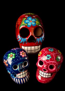 Colorful painted Day of The Dead (Dia de los Muertos) skulls isolated on black background