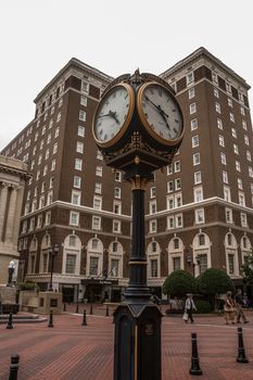 Downtown clock with buildings and people in the background at downtown Greenville, South Carolina