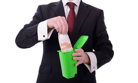 businessman putting euros into a bin isolated on white