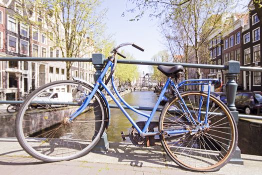 Old bike on a bridge in Amsterdam the Netherlands