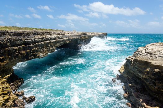 Waves Crashing on Rocks at Devil's Bridge Antigua in Sunshine