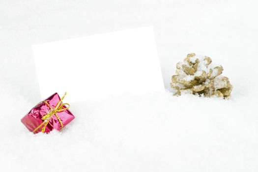 Blank white card with christmas decoration in the snow