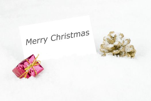 Blank white card with christmas decoration in the snow