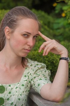 Beautiful young woman in park in summer