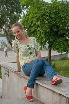 Beautiful young woman in park in summer