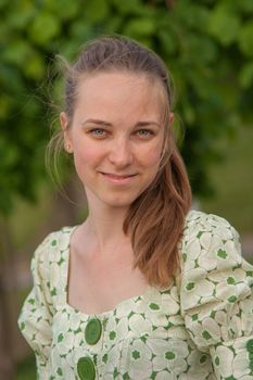 Beautiful young woman in park in summer