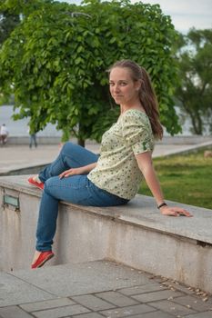 Beautiful young woman in park in summer
