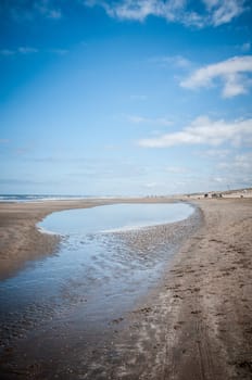 sea and beach with clouds and blue sky