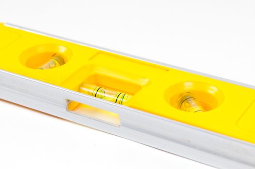 Yellow spirit level isolated on a white background