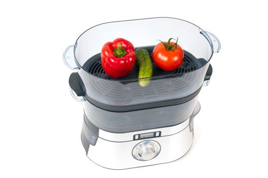 modern electric steamer with fresh vegetables on a white background 