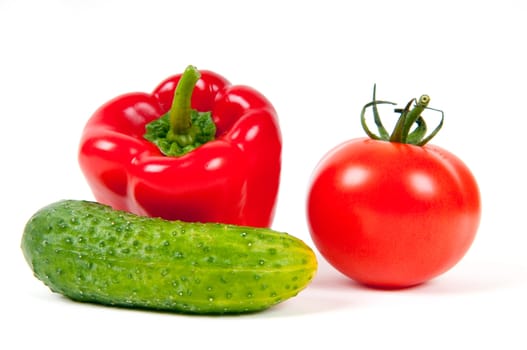 red pepper, tomato and green cucumber isolated on a white background