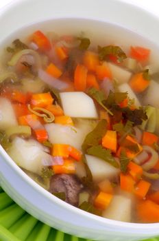 Simple Vegetable Soup with Potato, Carrot, Leek and Greens in Bowl closeup
