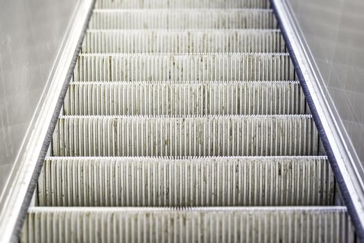 Closeup of a heavily used and worn escalator stairs