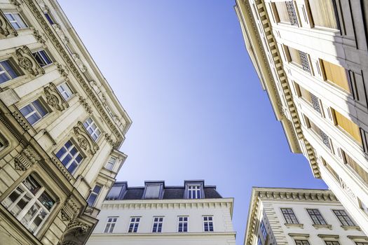 Historic building in Vienna, Austria photographed from below with blue sky for background