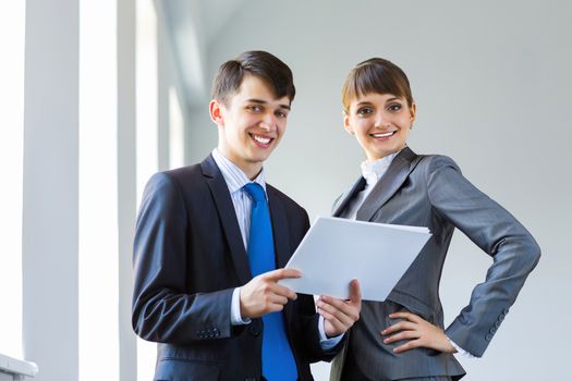 Young happy businessman and businesswoman people discussing project