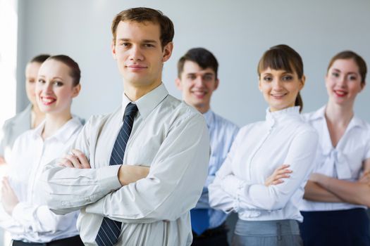 Young business people standing with arms crossed on chest