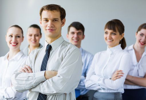 Young business people standing with arms crossed on chest