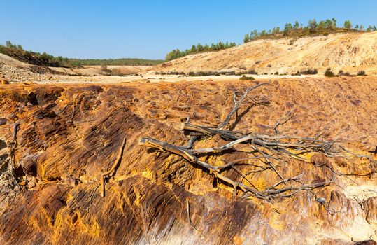 Earth dam wall with an empty dam in a dry dusty landscape