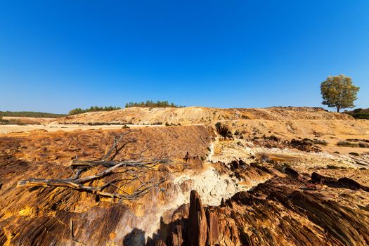 Earth dam wall with an empty dam in a dry dusty landscape