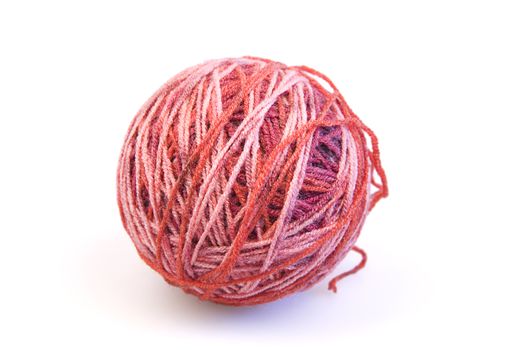 Red ball of woolen threads on a white background