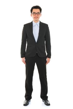 Confident full body Asian business man in formal full suit standing isolated on white background