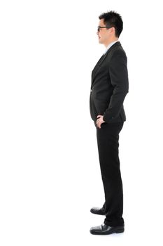Side view full body Asian business man in formal suit standing isolated on white background