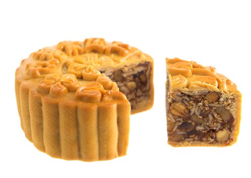 Traditional mooncake cutted isolated on white background. Chinese mid autumn festival foods. The Chinese words on the mooncake means assorted fruits nuts, not a logo or trademark.