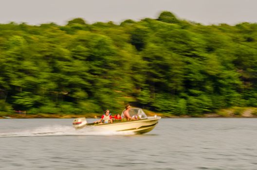 abstract fast moving boat on a lake