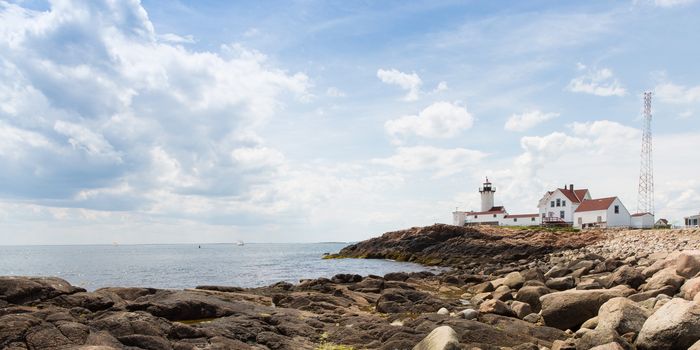This is the Eastern Point Lighthouse sitting on a point of land extending from Gloucester Harbor in Massachuisetts.