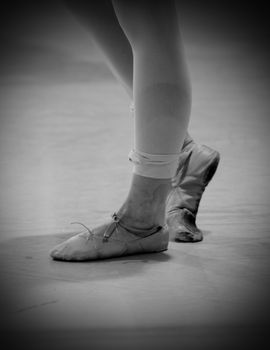 sore dancer's feet with old shoes and bandage