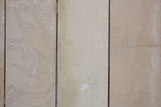 The texture of painted building cement tiles beige, a vertically