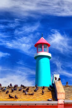 A Lighthouse with Backdrop of Blue Sky and Clouds