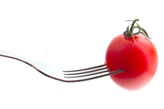 cherry tomato on fork isolated on white