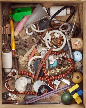 Various objects in old wood drawer - detail