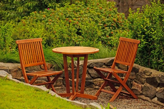 Classic hardwood garden furniture in a summer garden