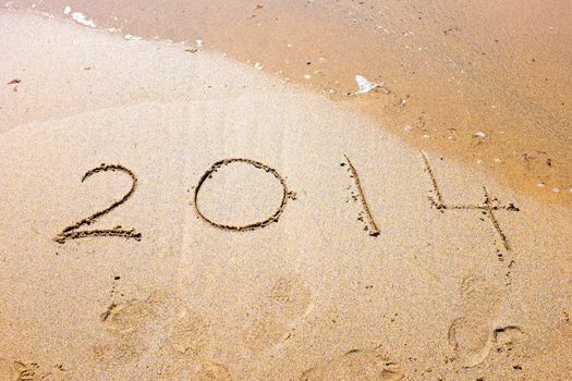 Happy New Year, 2014 written in sand at the beach