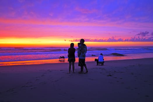 People watching an incredible sunset at the westcoast in Portugal