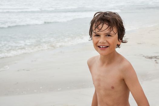 smiling little kid boy child on the beach in summer vacation portrait outdoor