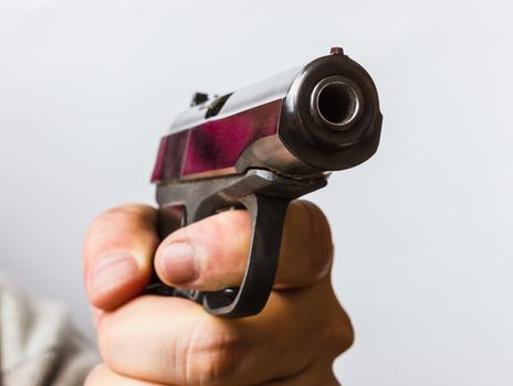 Aggressive man with a black gun in his hand